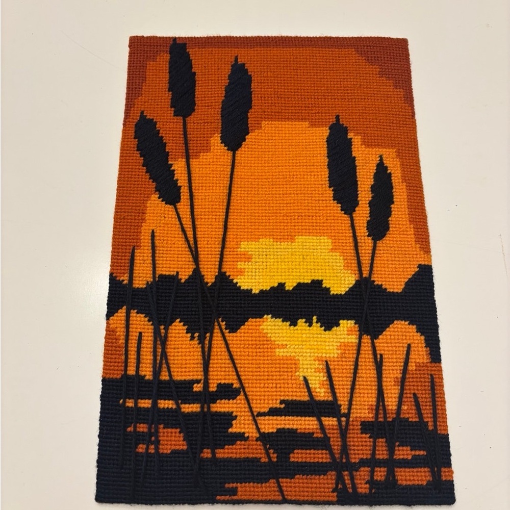 vintage needlepoint from 1975 featuring a sunset over a marsh with cattails